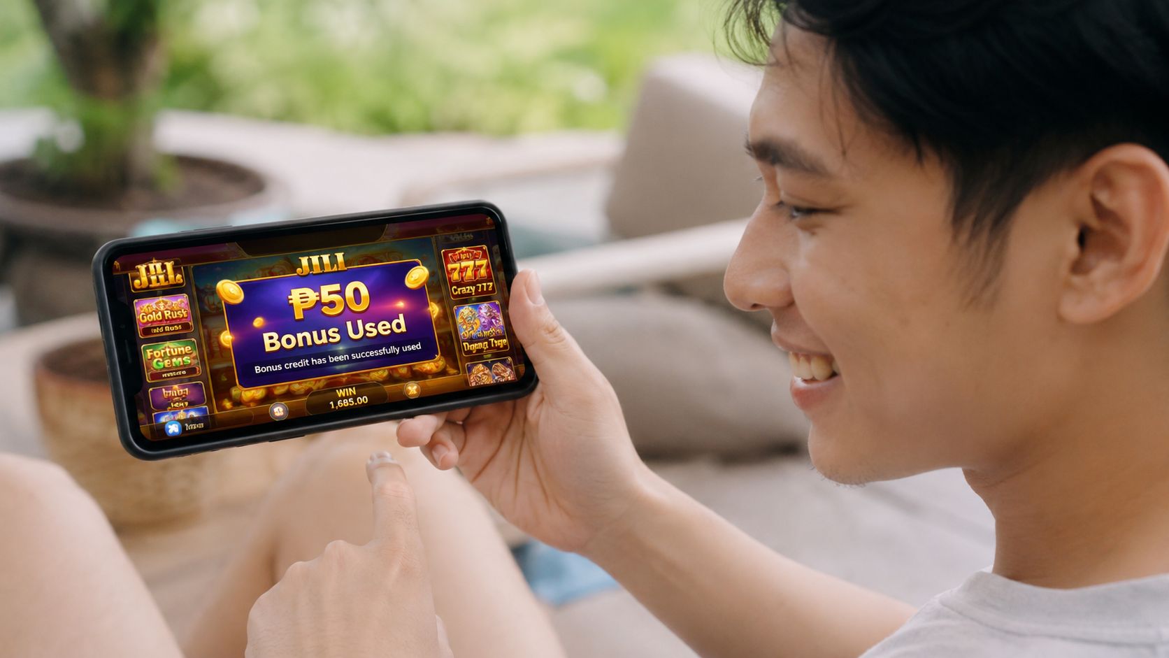 A smiling young man holding a smartphone displaying an online casino slot game with a bonus message.